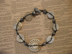 bracelet: ivory buttons/silver beads on linen cord